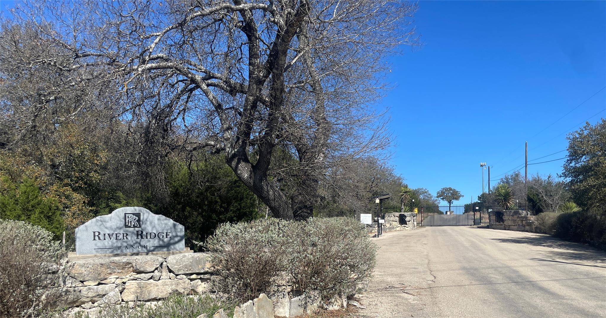 View of asphalt road featuring a gate