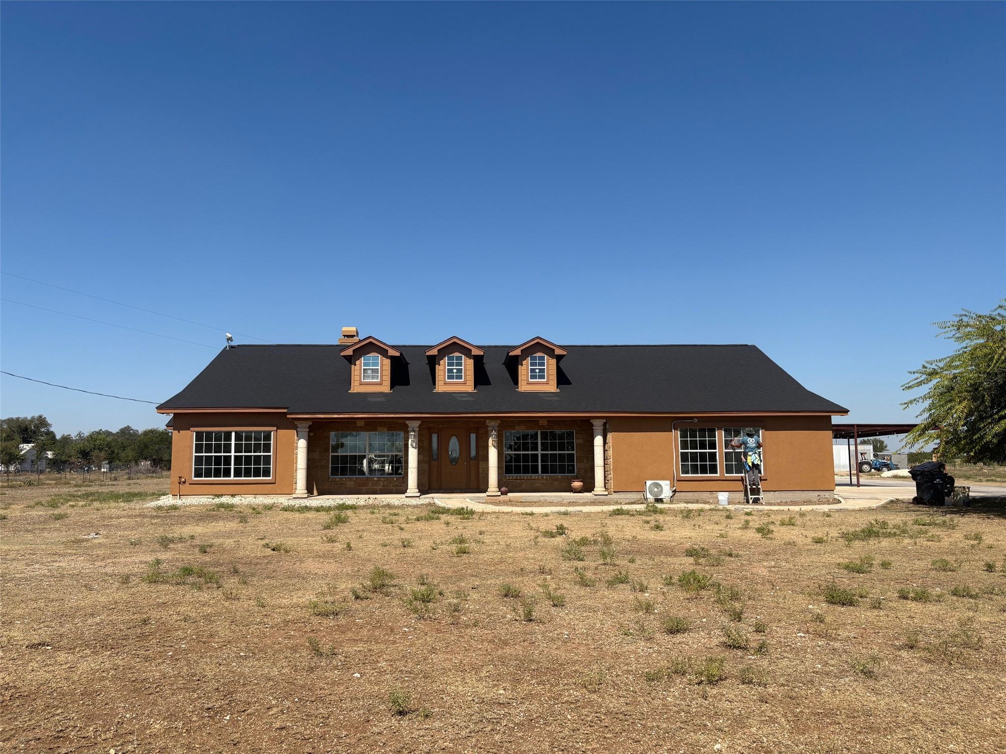 Cape cod-style house with a porch