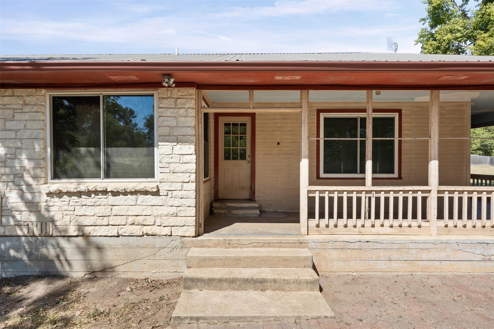 Entrance to property featuring covered porch, sto