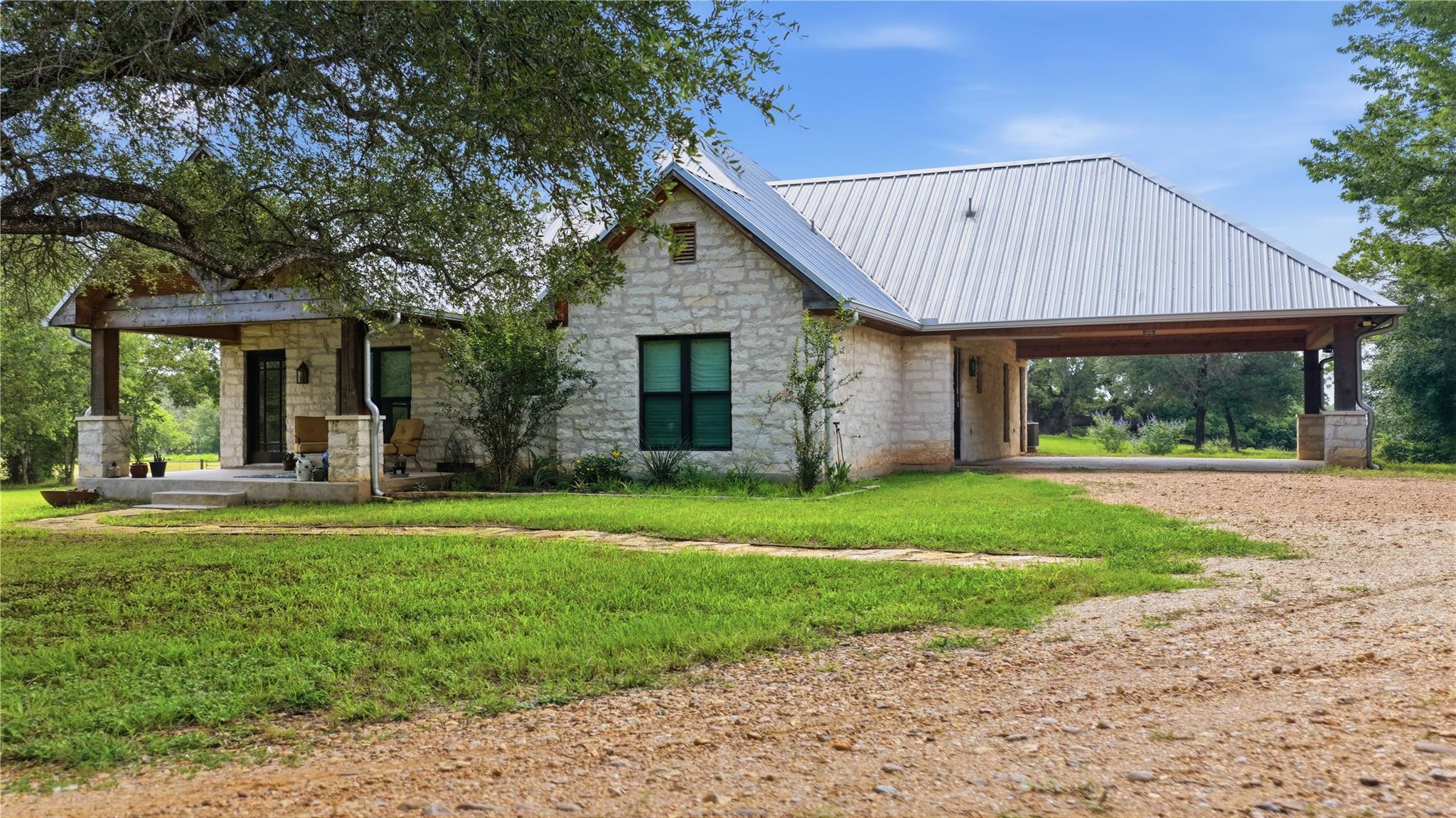 A striking stone exterior, covered porch, and met