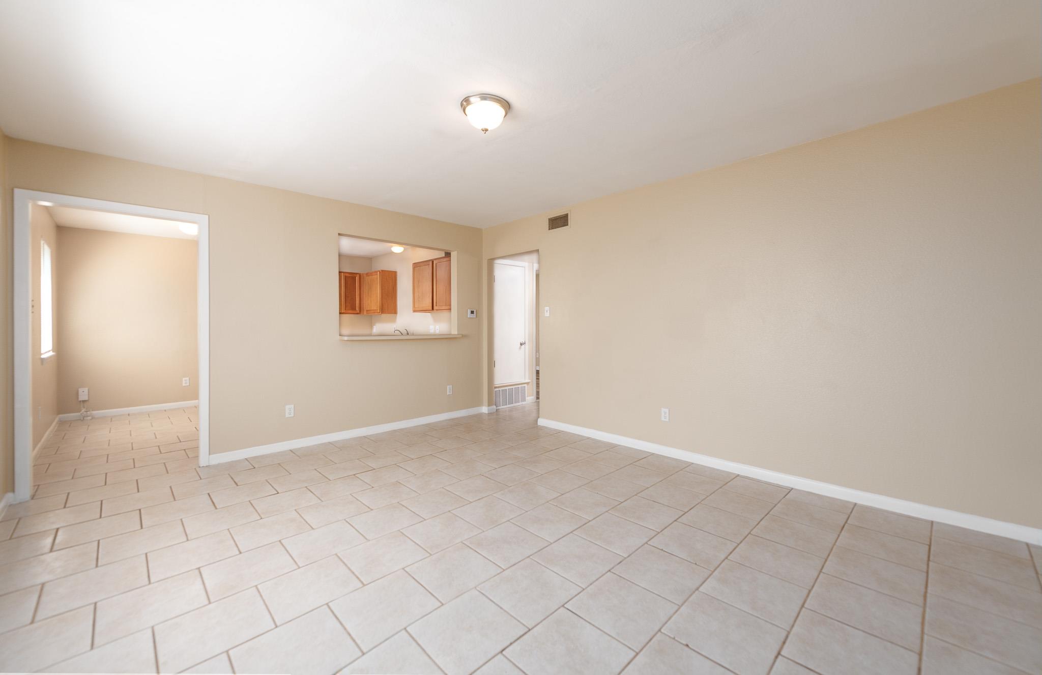 Unfurnished room featuring light tile patterned f