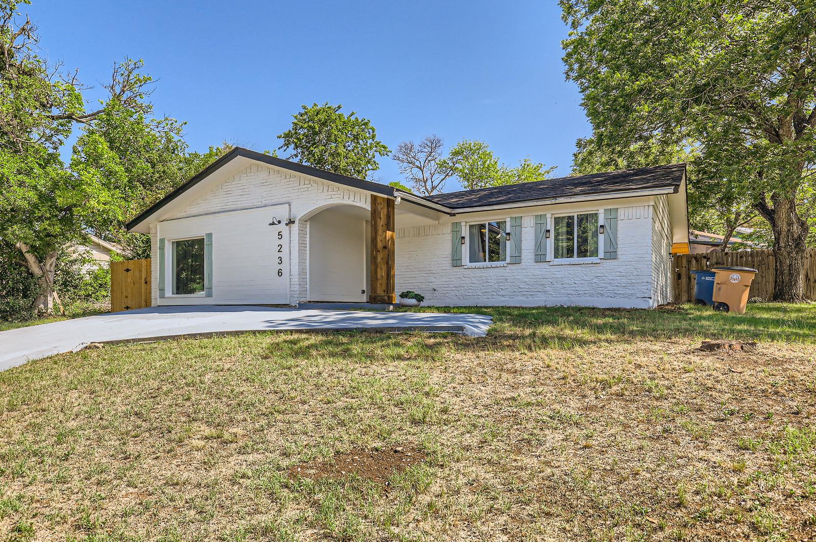 Single story home featuring brick siding