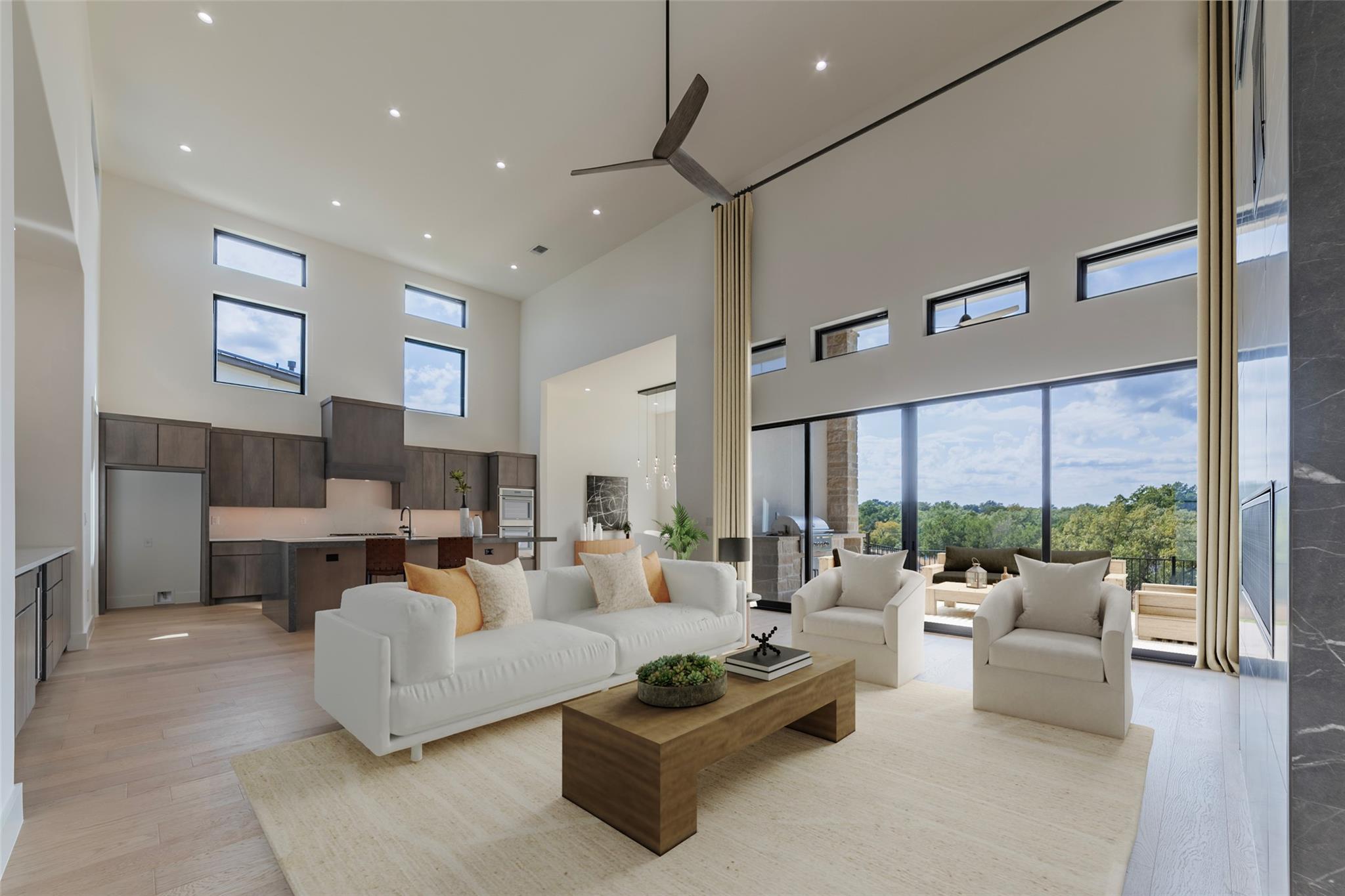 Living area with a towering ceiling, light wood f