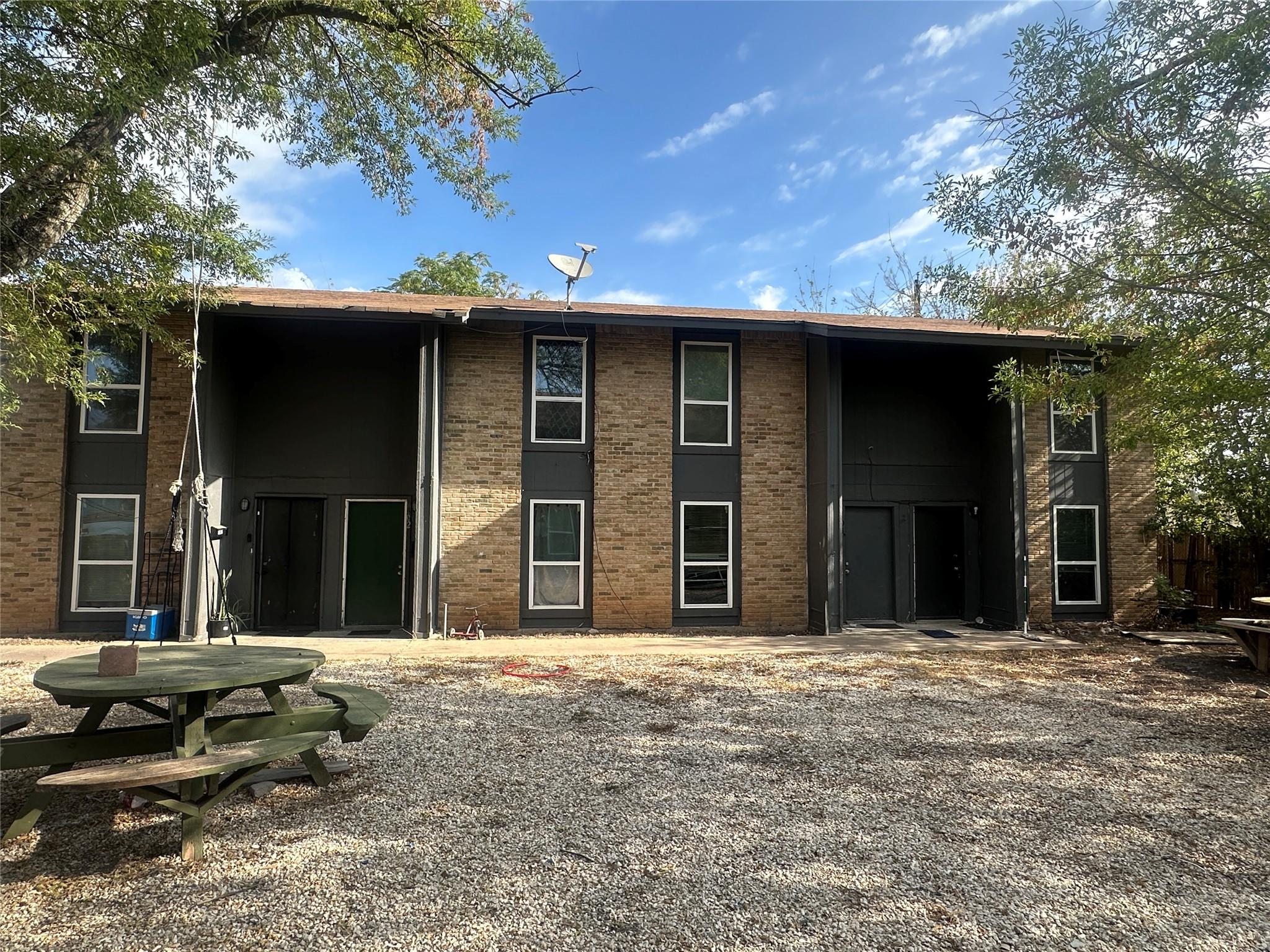 Rear view of property featuring brick siding and 