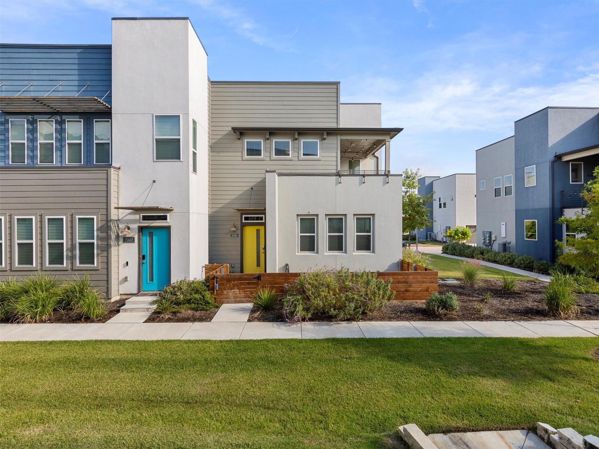 Modern home with a front lawn and stucco siding