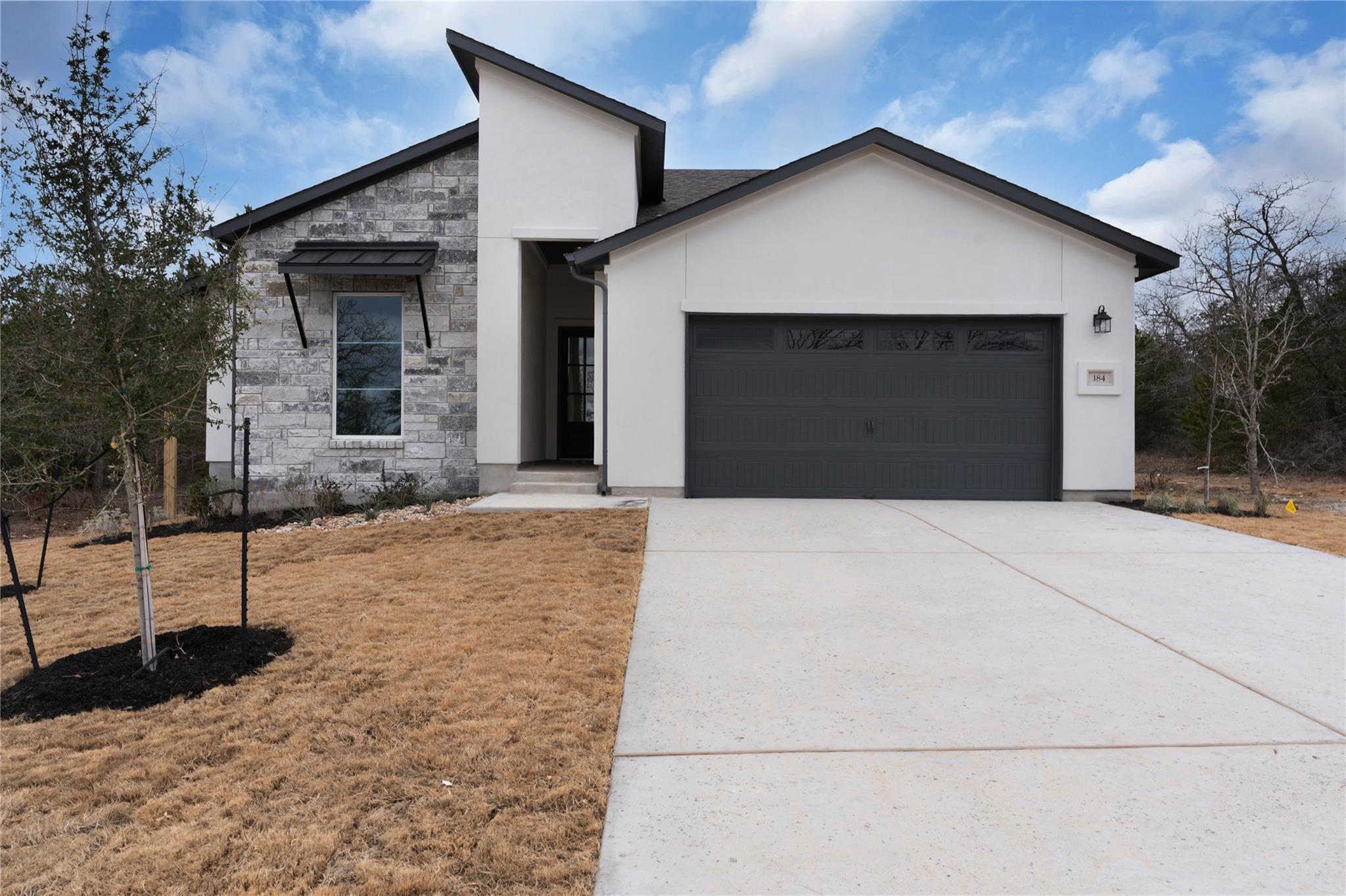 Contemporary home with stone siding, stucco sidin