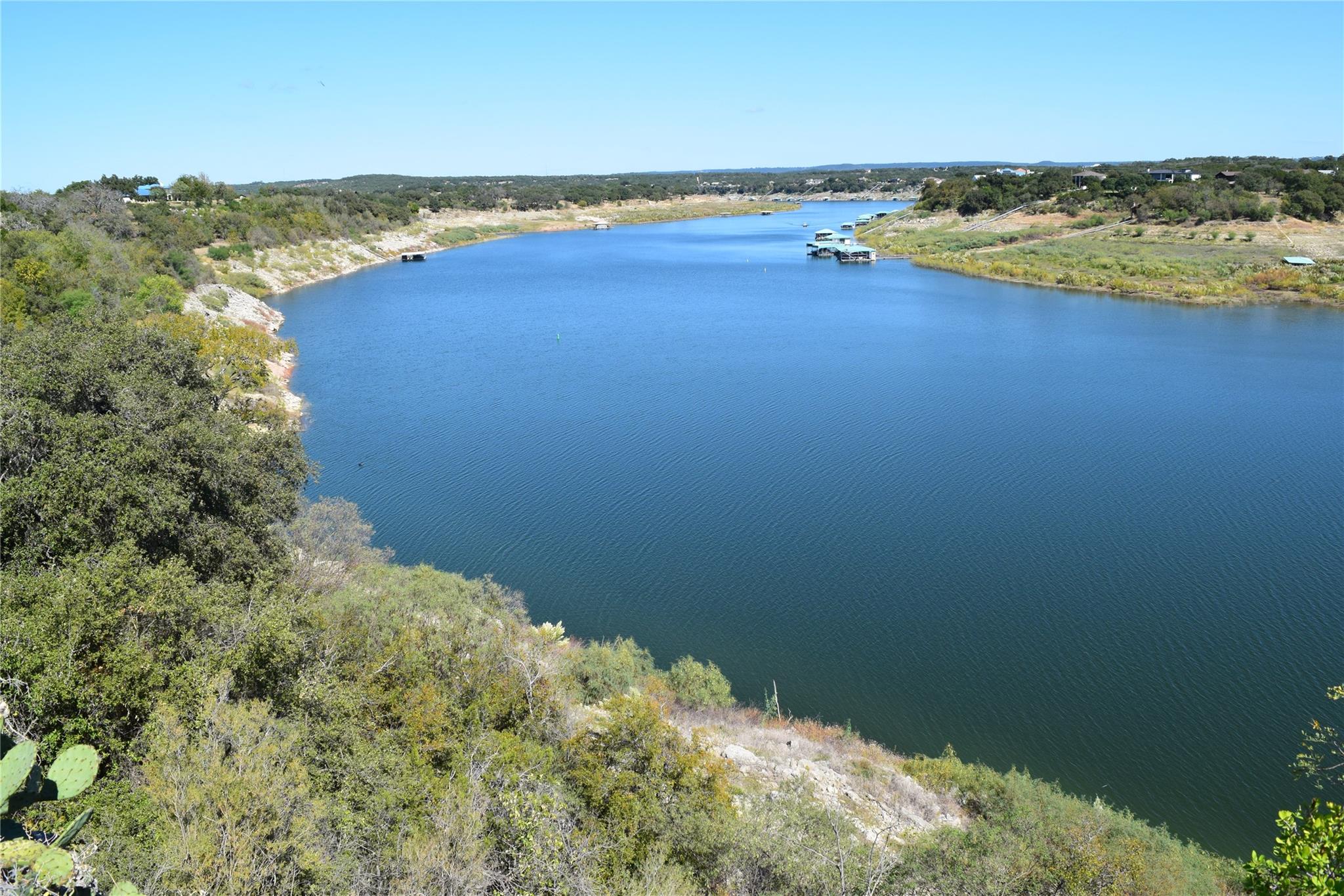 Aerial view of a nearby body of water and a forest