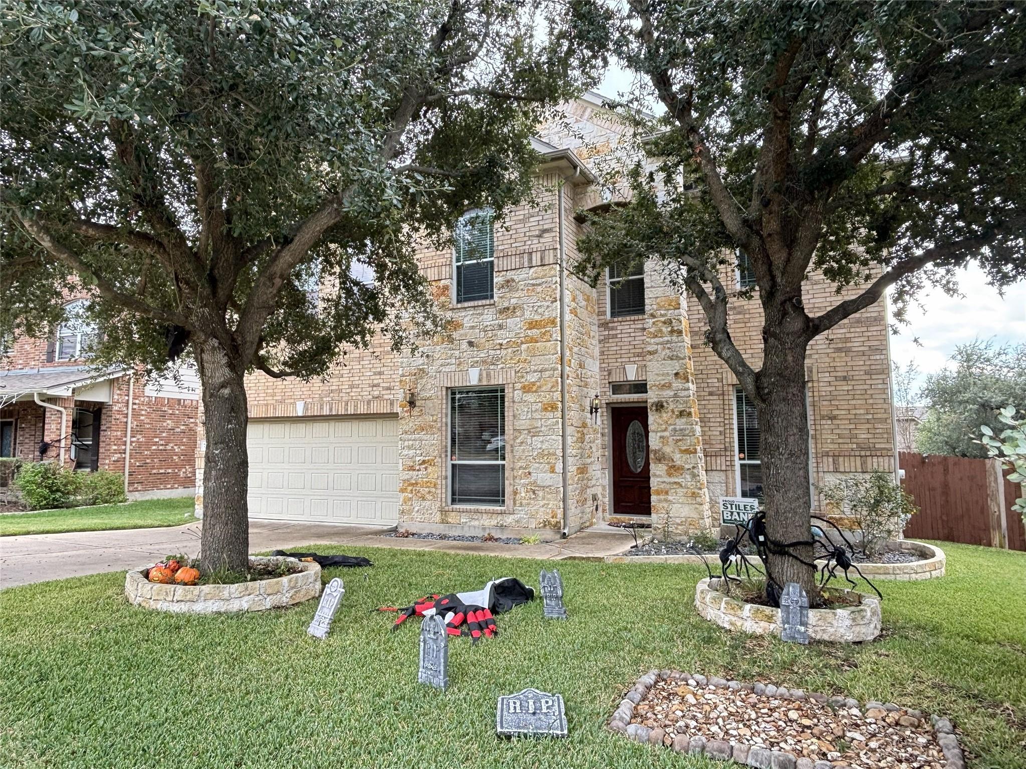 View of front facade featuring concrete driveway,