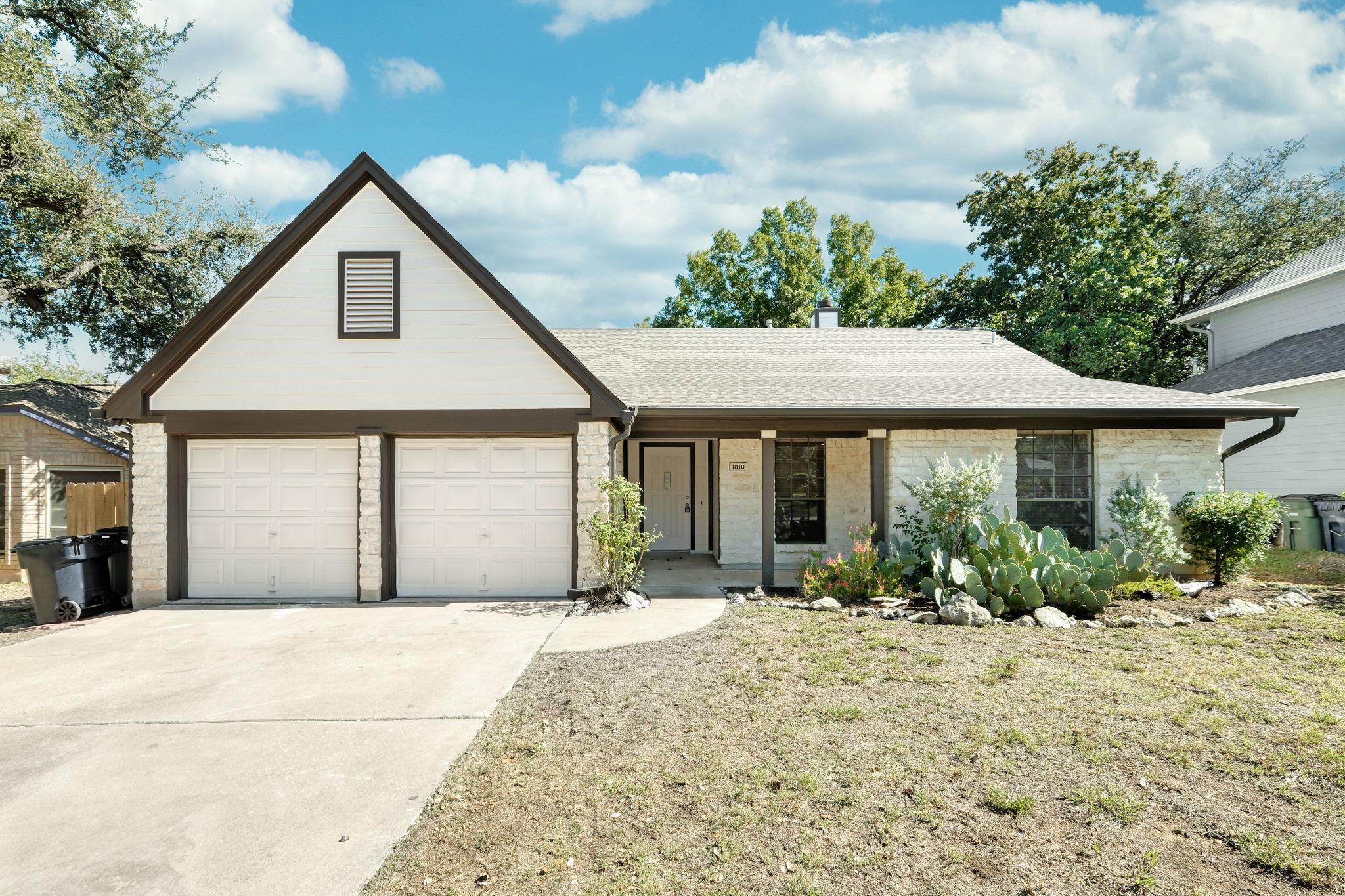View of front of property with concrete driveway,