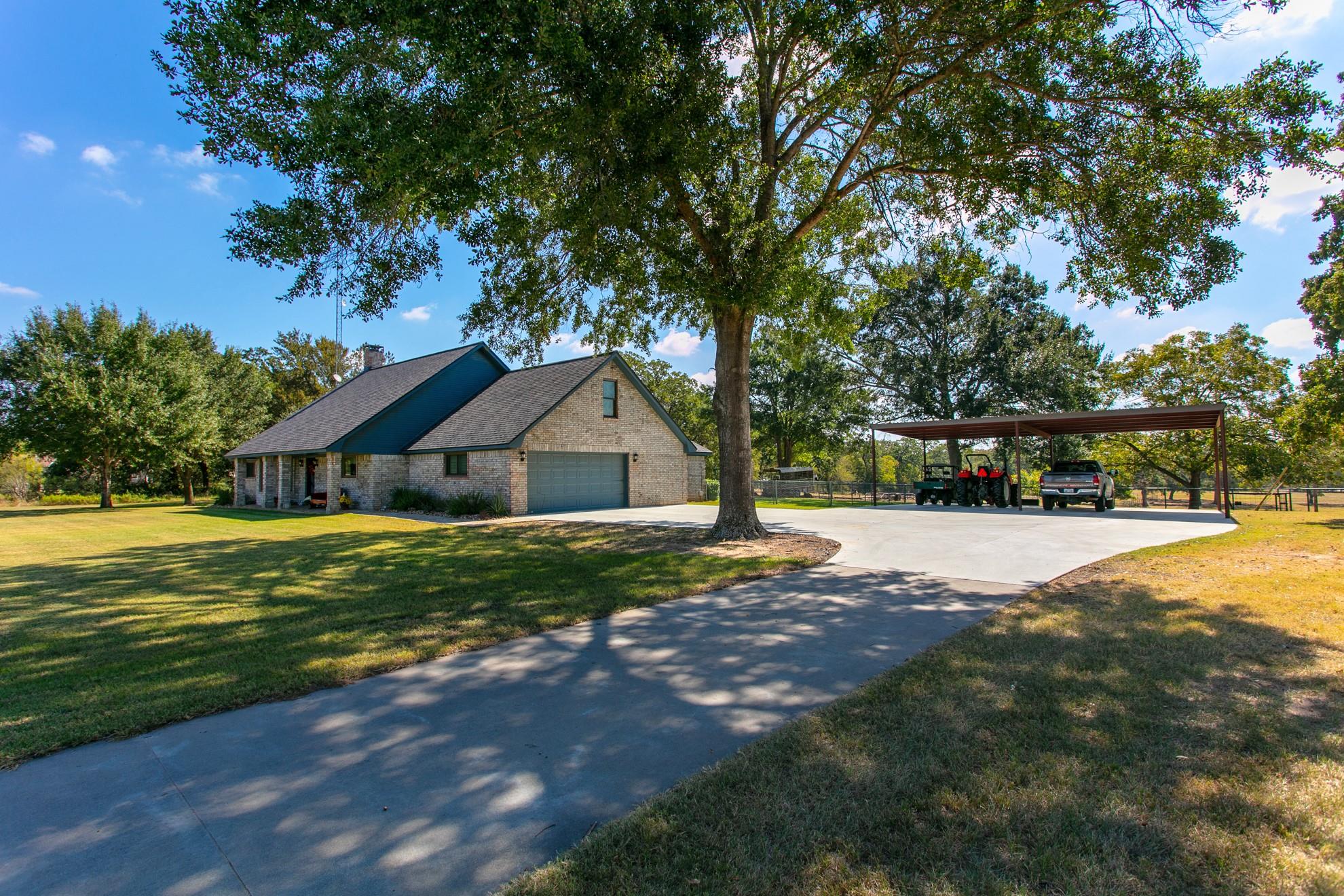View of front facade featuring concrete driveway,