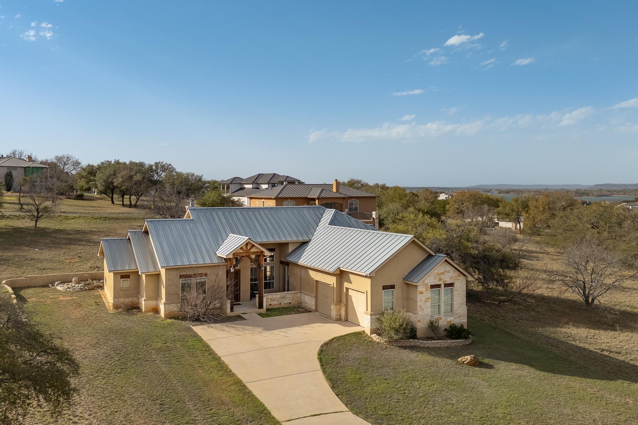 The property features a concrete driveway, a two-