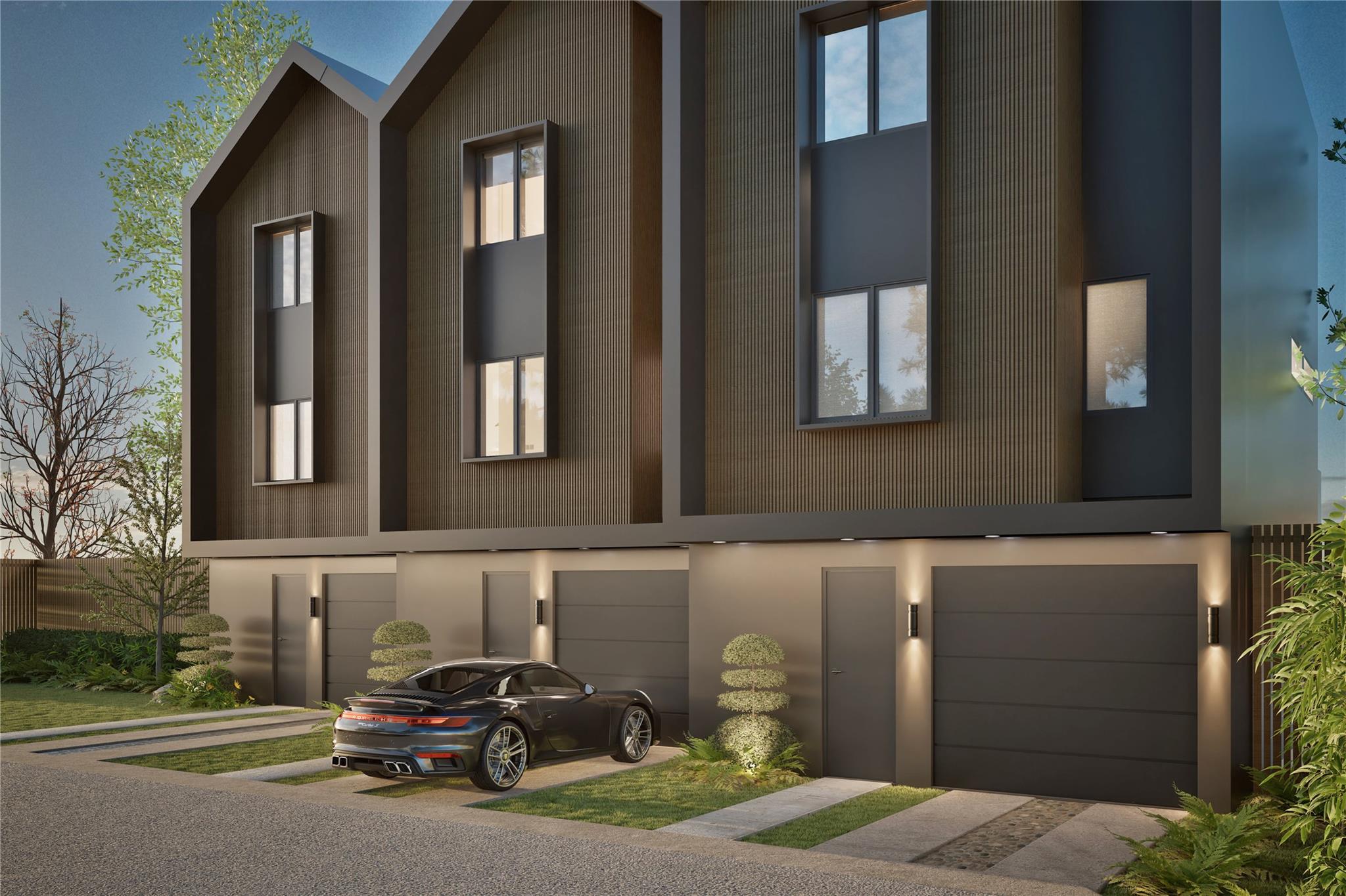View of front of house with a garage, driveway, a