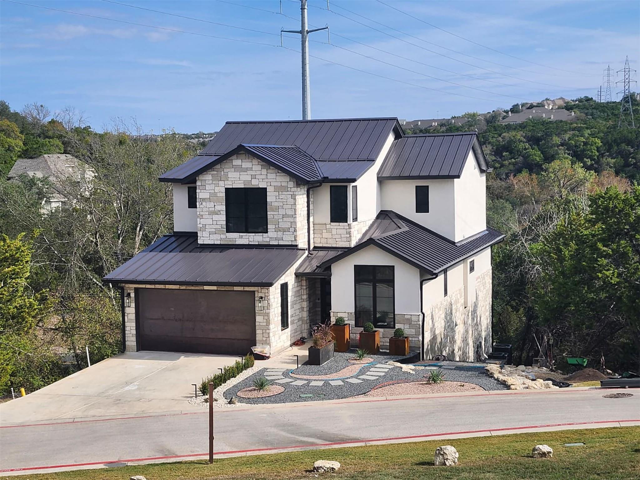 Modern inspired farmhouse featuring stone siding,