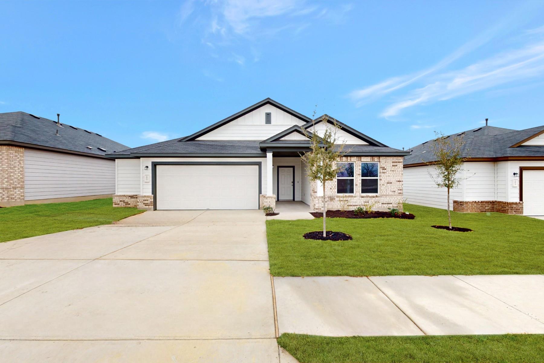 Ranch-style home with a front lawn, concrete driv