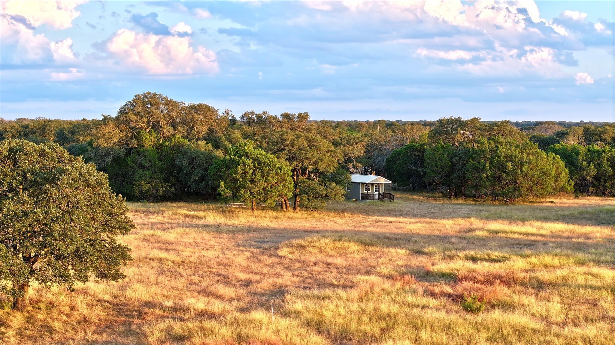 View of yard with a view of countryside and a woo