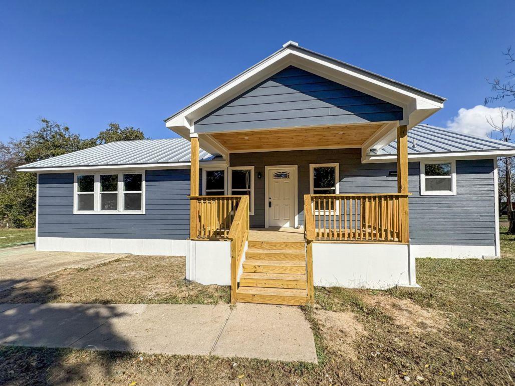 View of front of home featuring a metal roof, a p