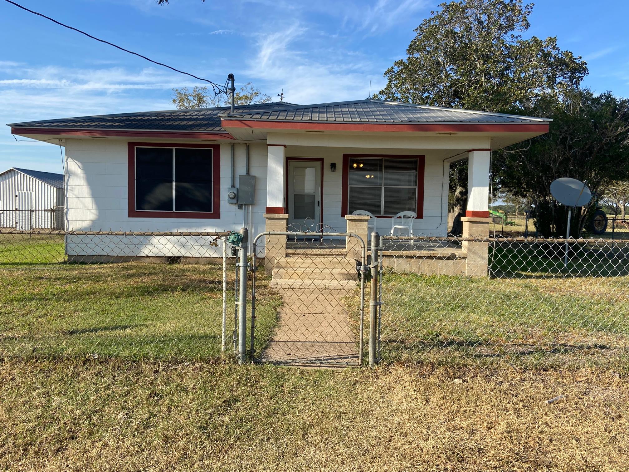 View of front facade featuring a gate, a porch, a