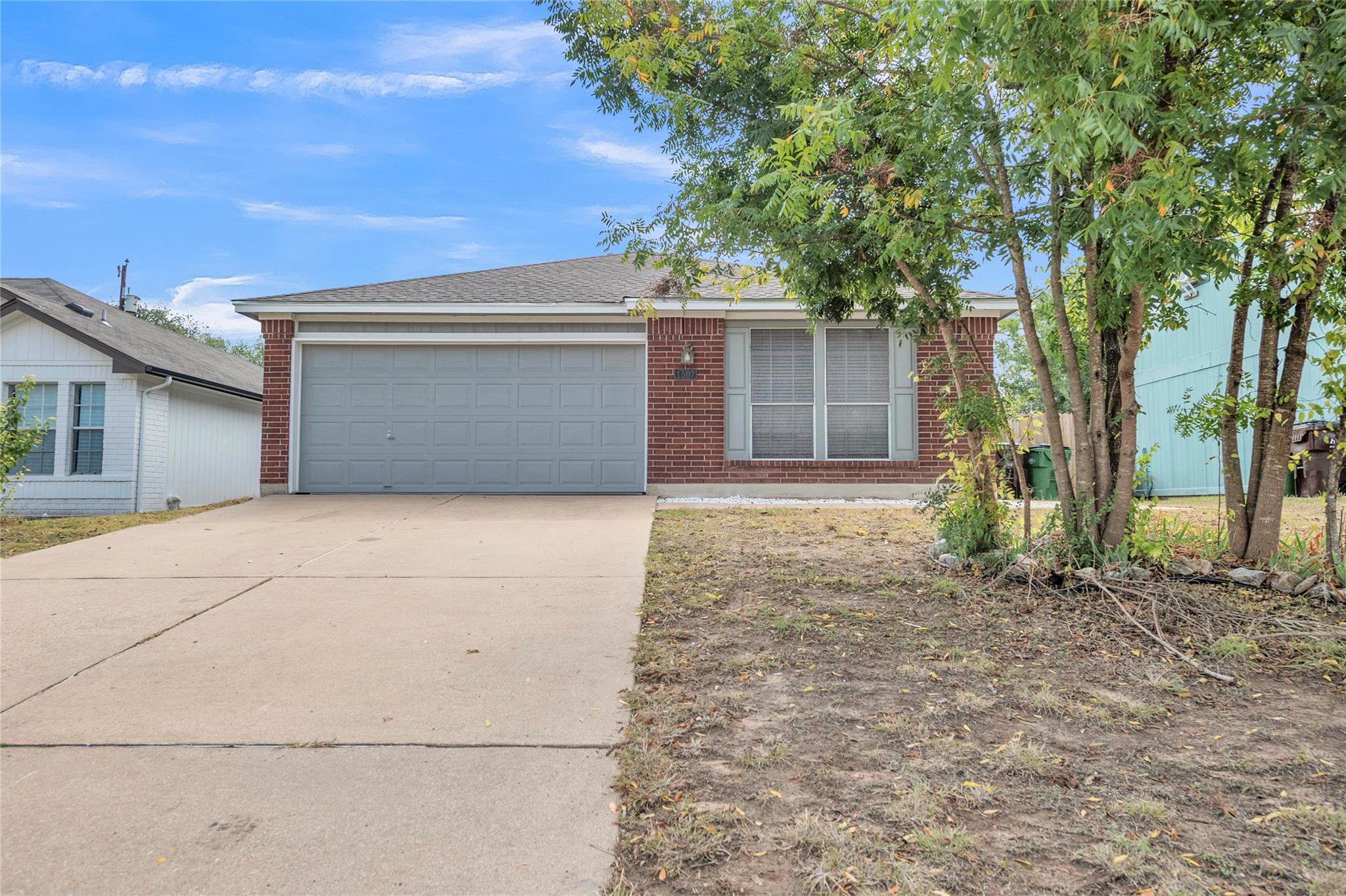 View of front of house with driveway, a garage, a