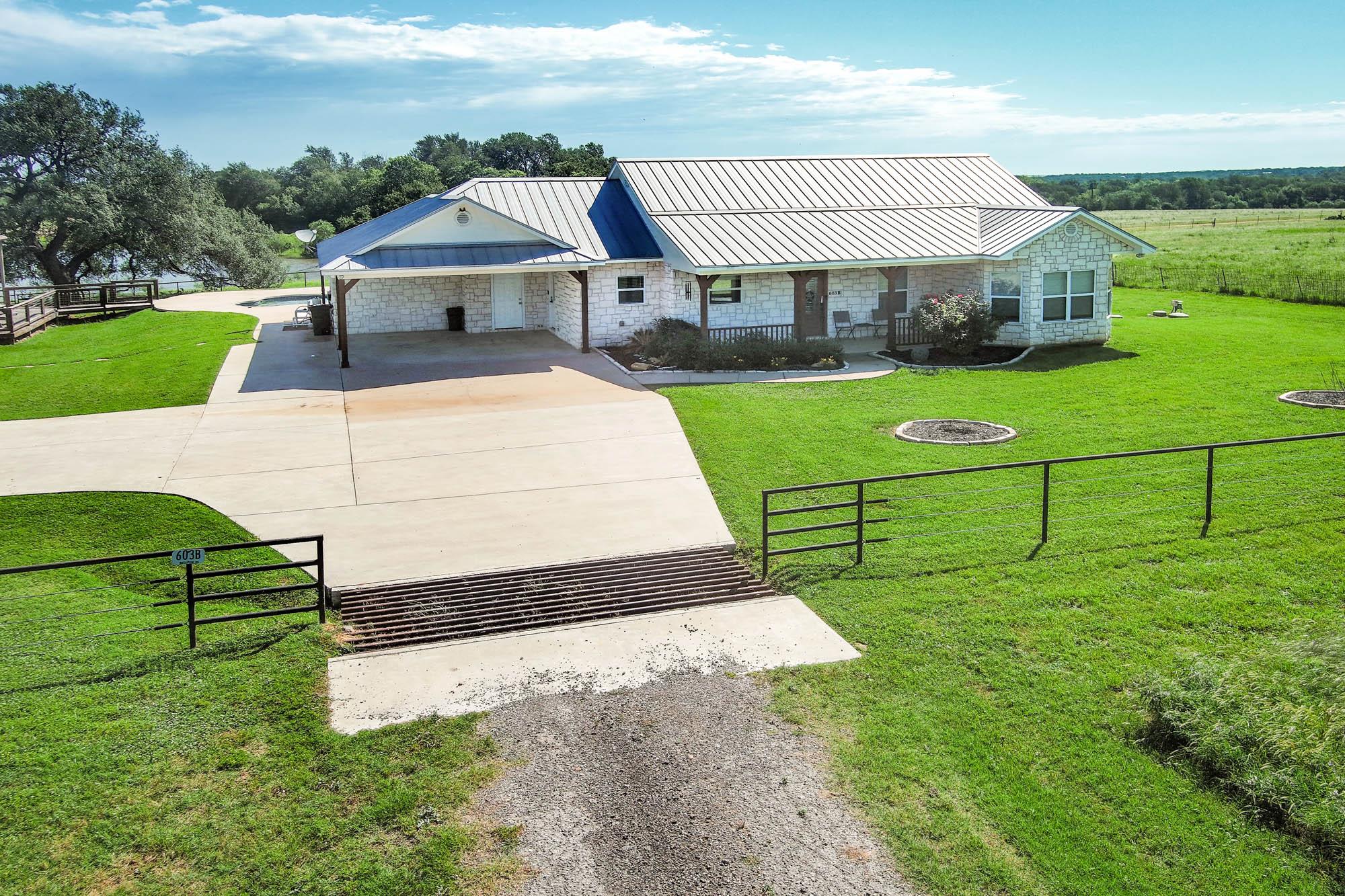 Stone exterior home featuring a metal roof and an