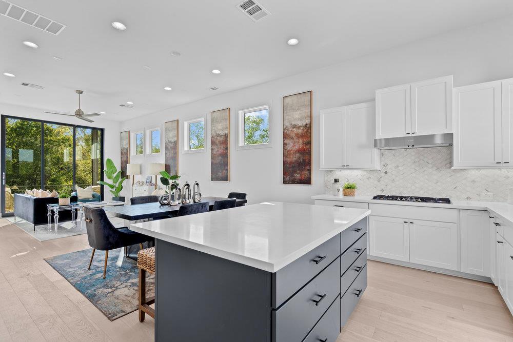 Kitchen featuring white cabinetry, a kitchen brea