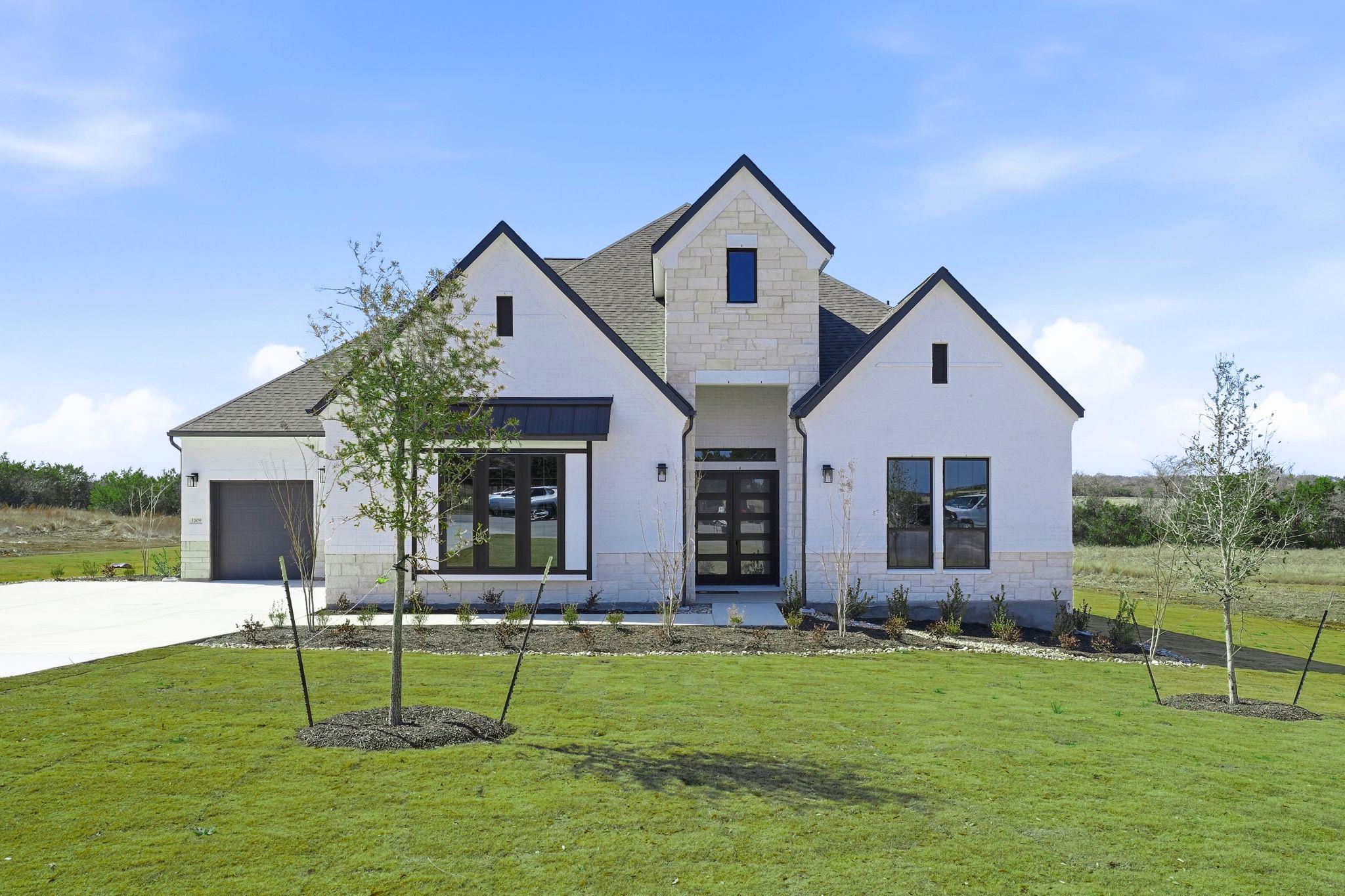 View of front of house featuring stone siding, a 