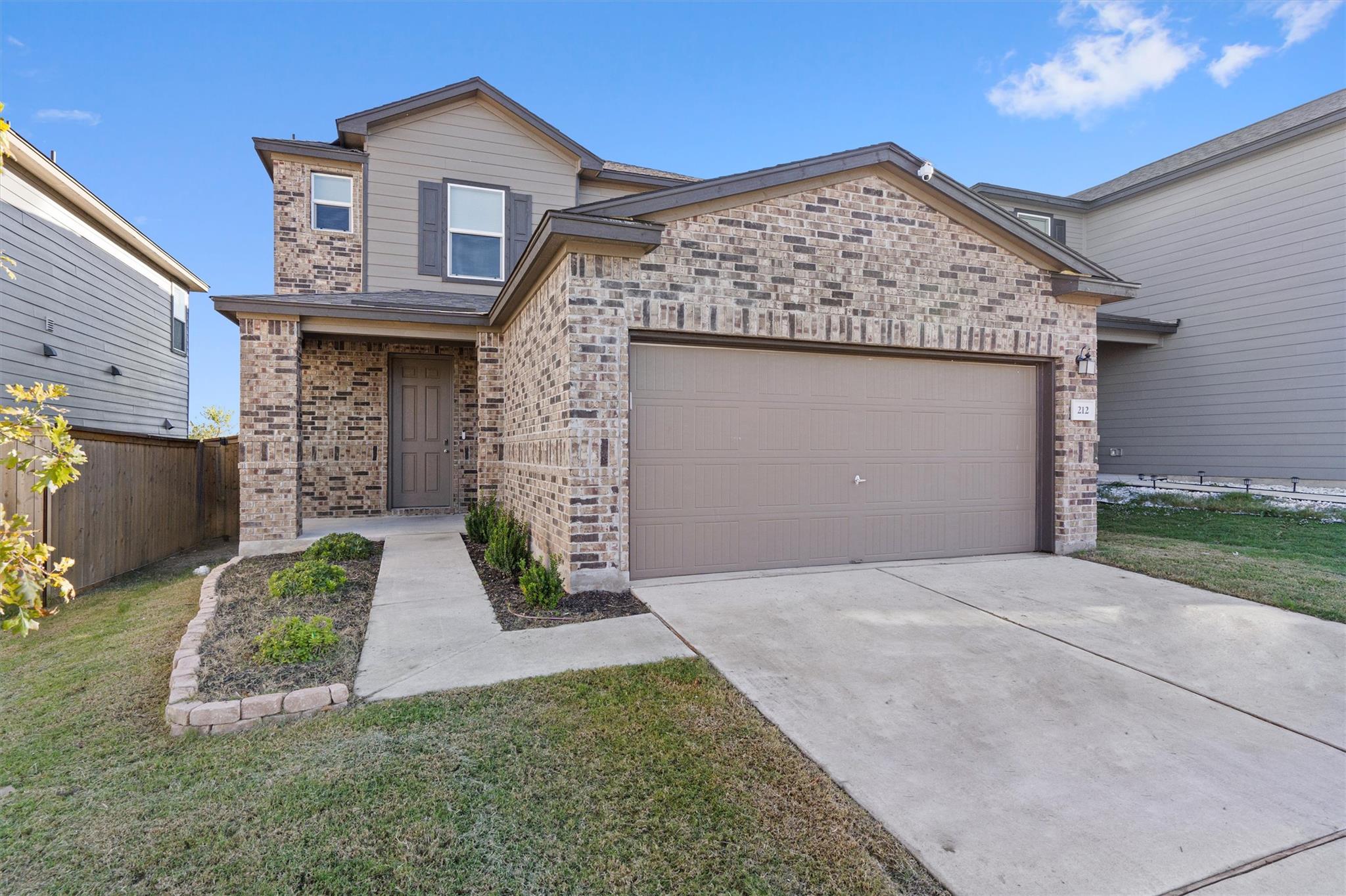 View of front of home with brick siding, concrete