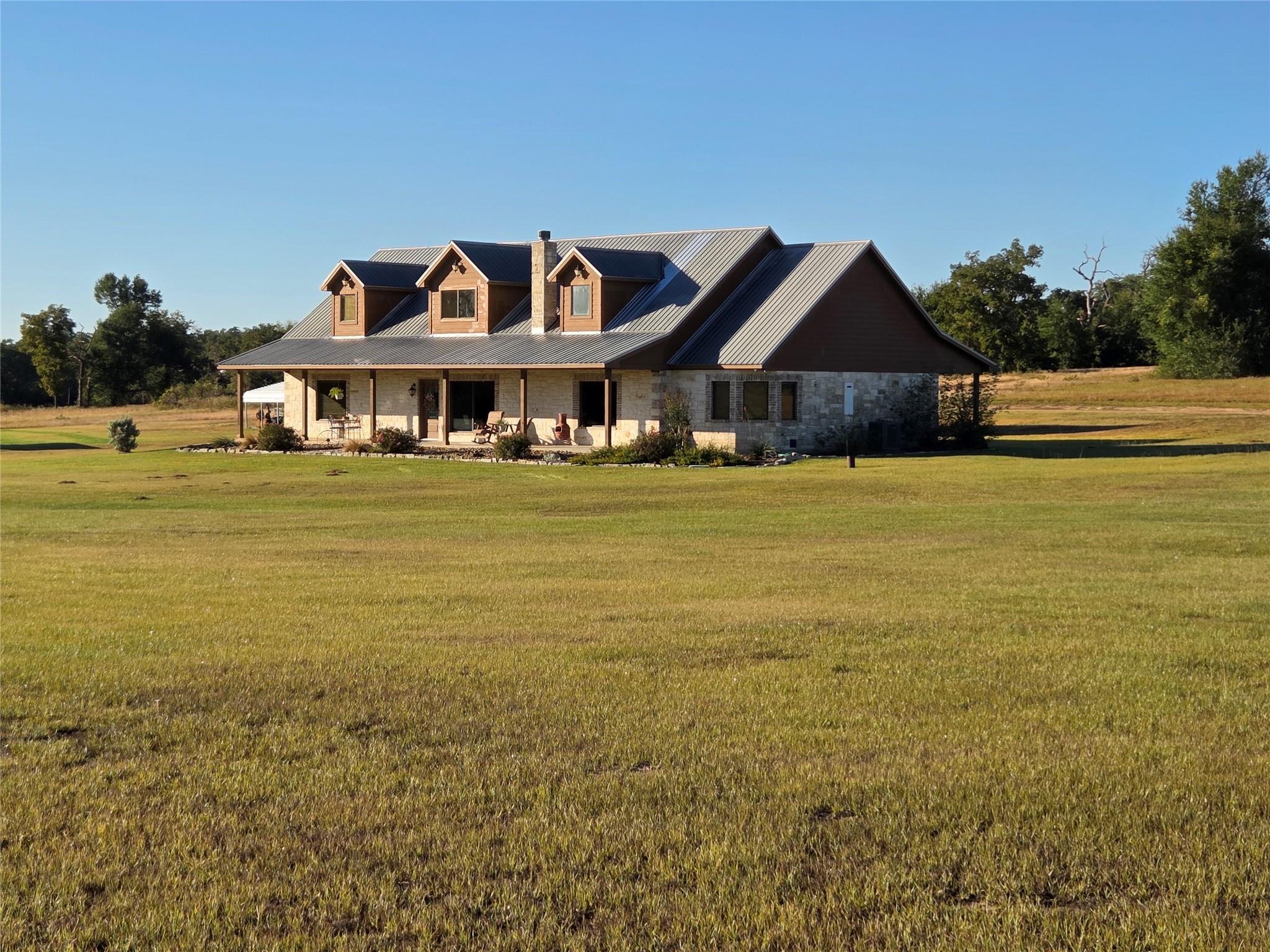 View of front of house with covered porch, a fron