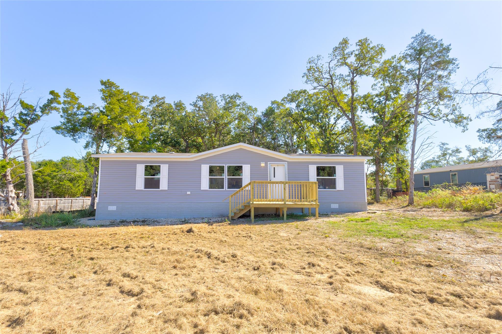 View of front of home with crawl space and a deck