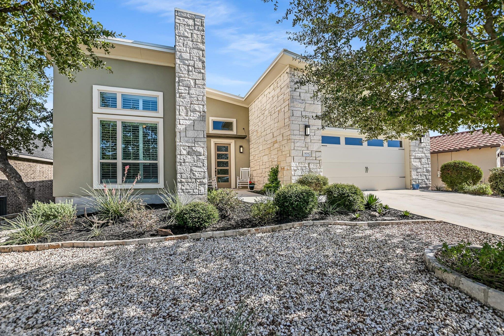 View of front of house with concrete driveway, st