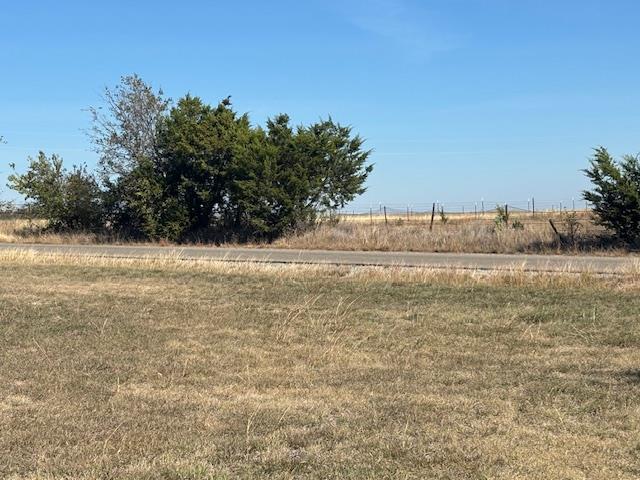 View of yard with a rural view