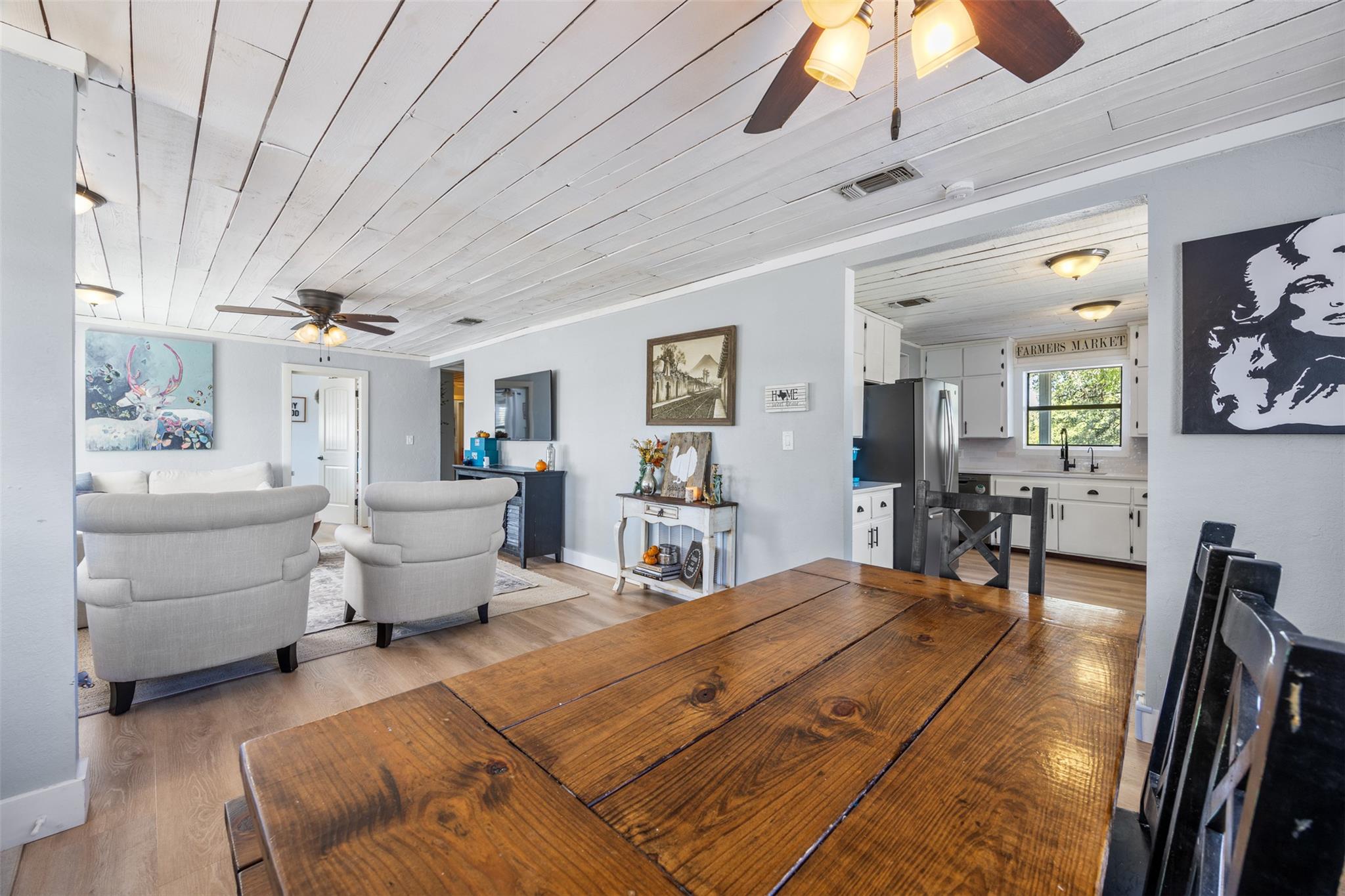 Dining area with ceiling fan, wooden ceiling, lig