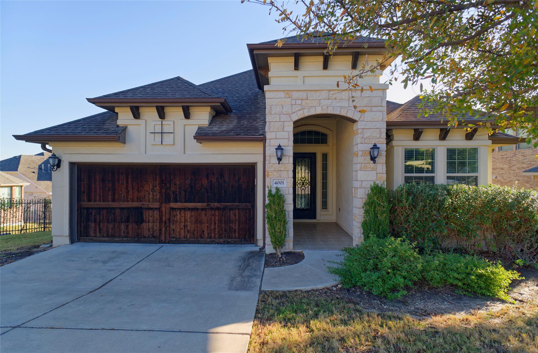 View of front of house featuring stone siding, a 