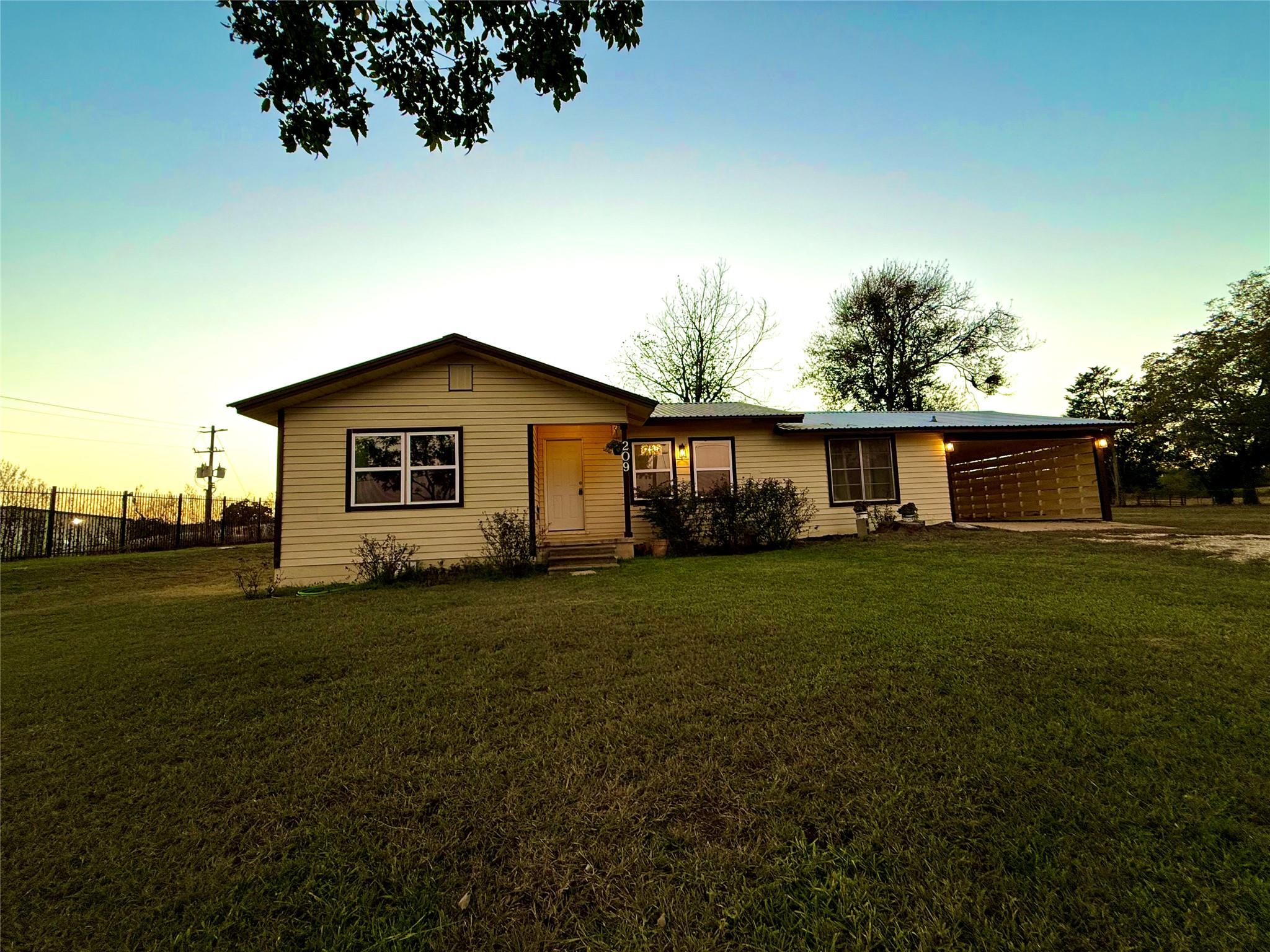 View of front of home with an attached carport, d