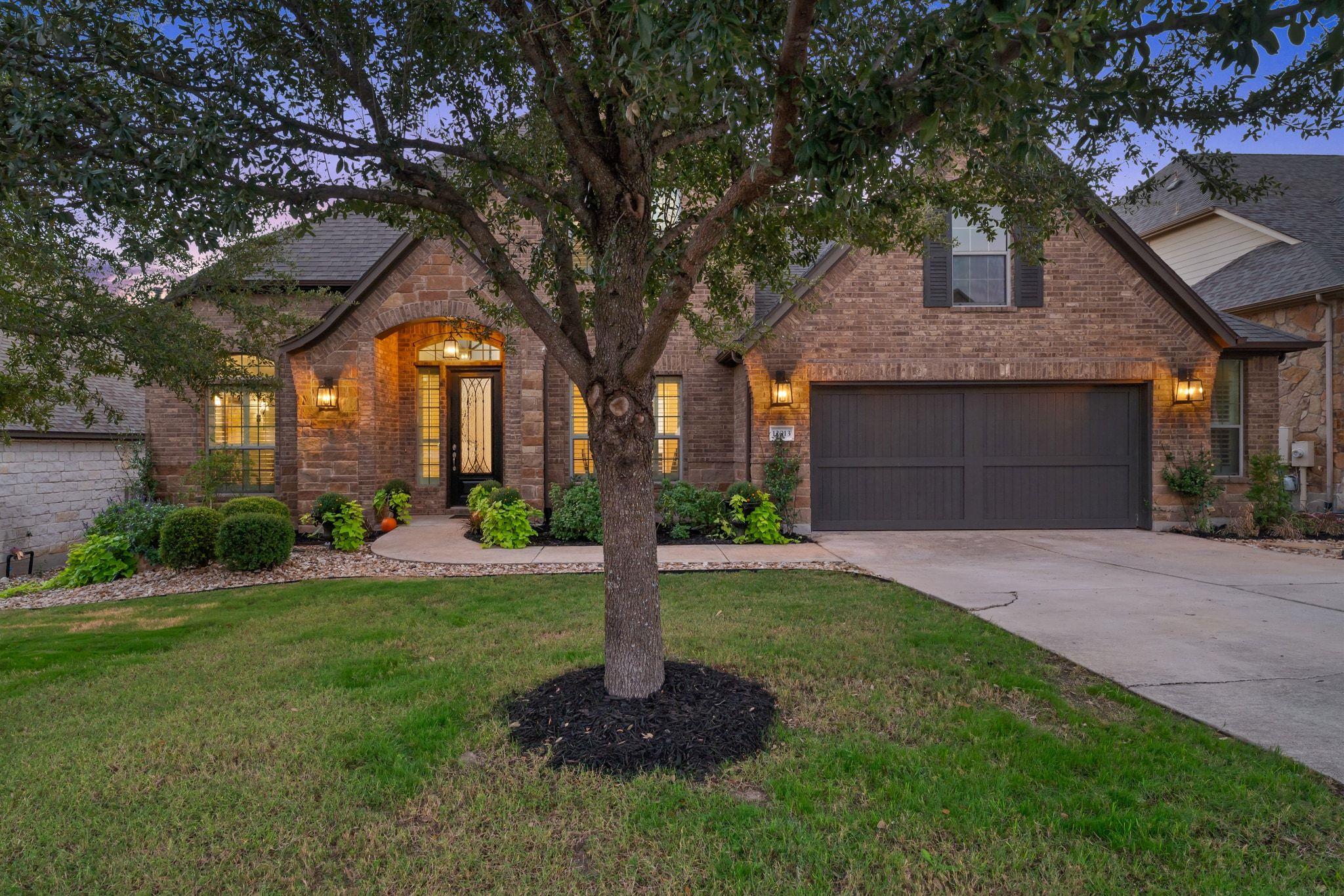 View of front of home featuring a yard, brick sid