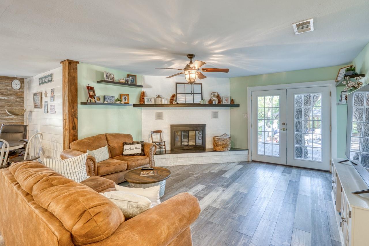 Living room with a fireplace, wood finished floor