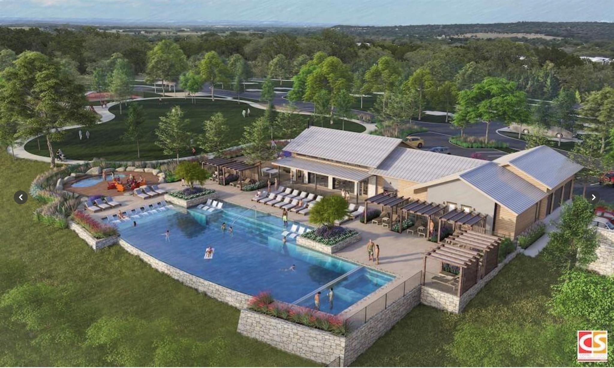 Bird's eye view of a pool area and a heavily wood
