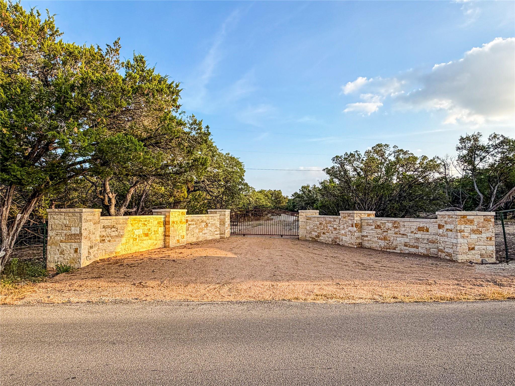 View of yard with a gate and view of wooded area