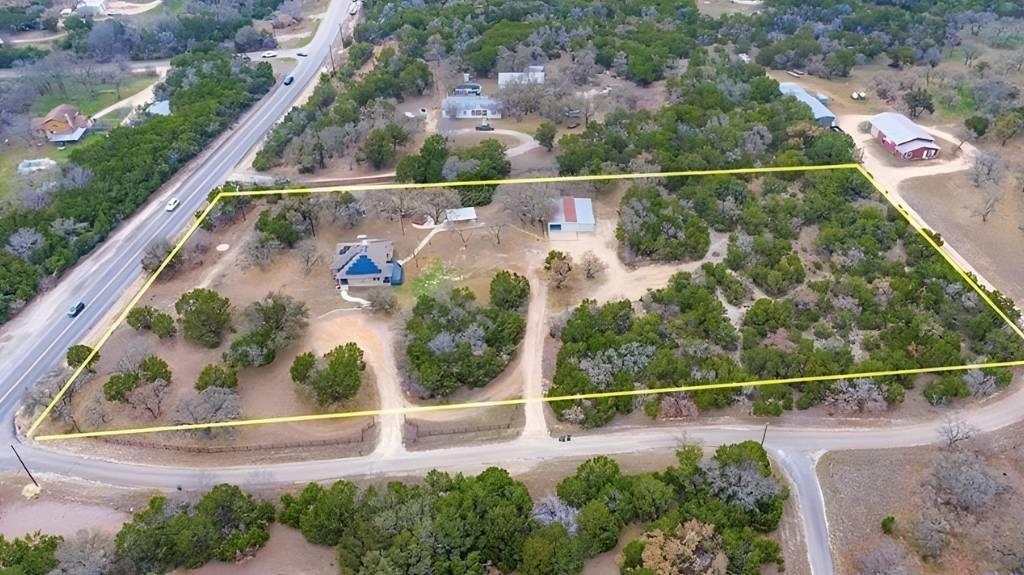 Aerial view of property's location featuring a tr