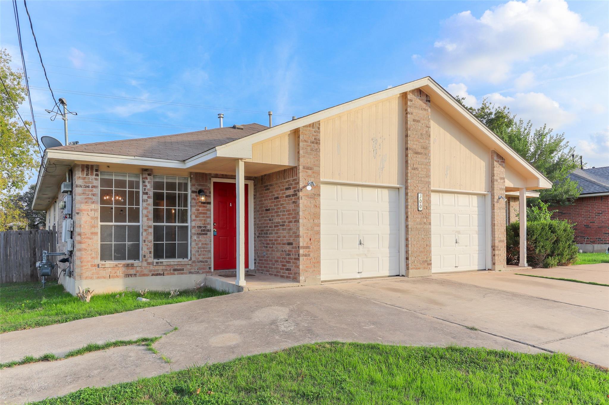 View of front of property featuring concrete driv