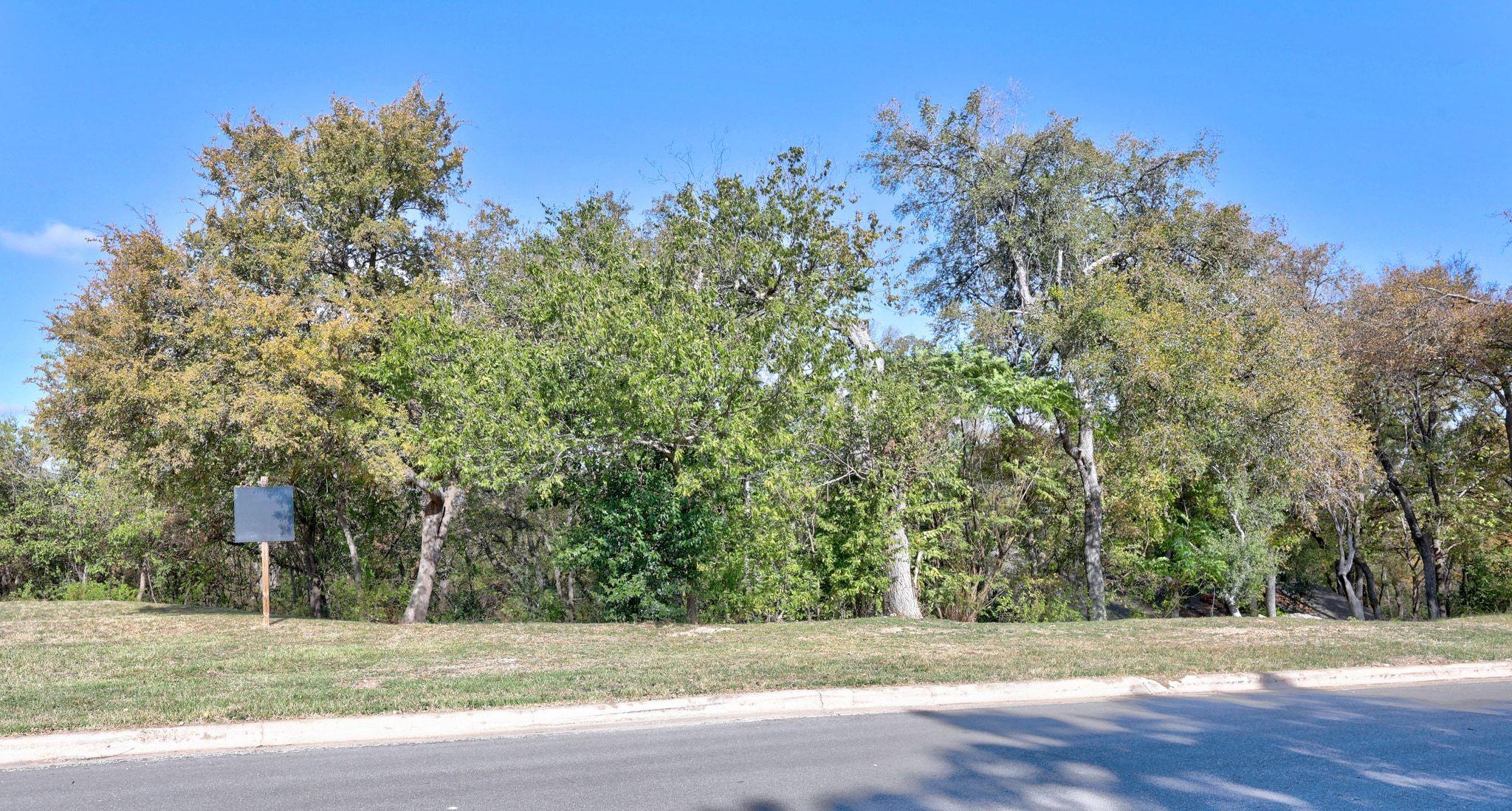 View of asphalt road featuring curbs