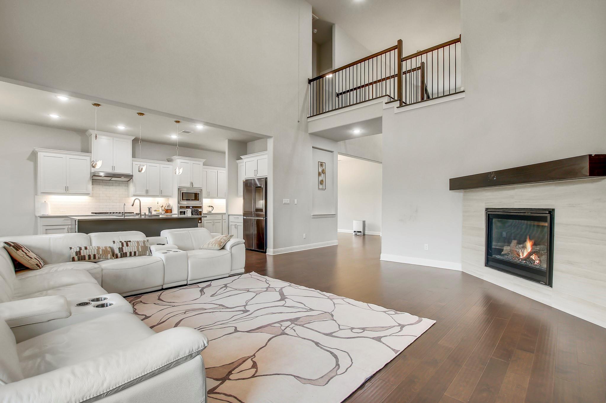 Living room featuring dark wood-style floors, a t