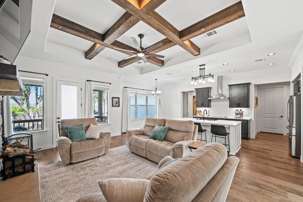 Living room featuring coffered ceiling, a ceiling