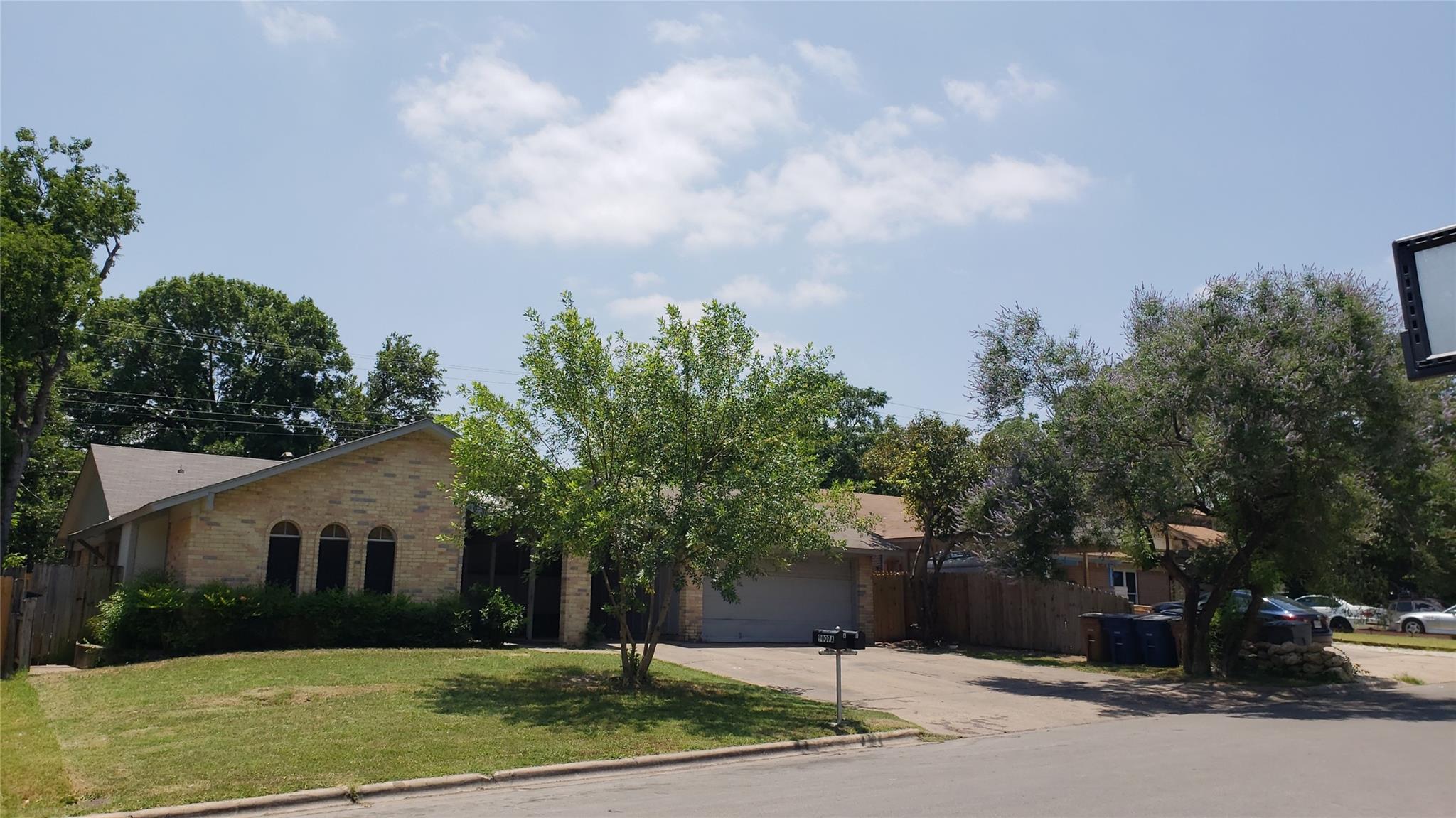 View of front of home featuring driveway, brick s