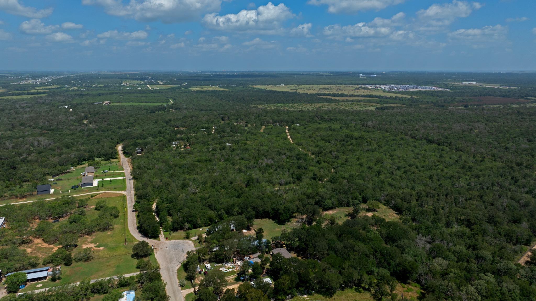 An aerial perspective reveals vast woodlands and 