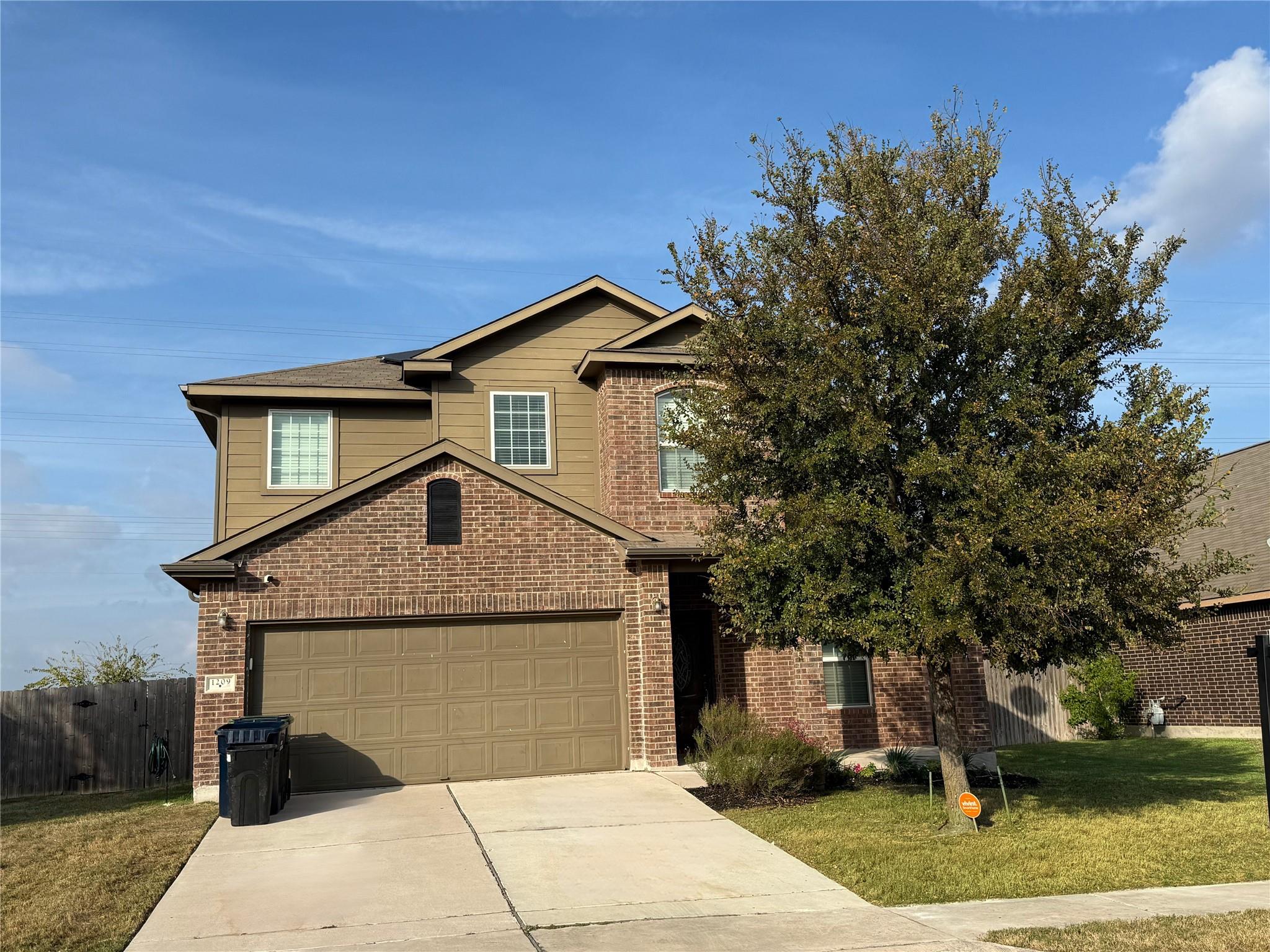 Traditional home featuring a garage, driveway, an