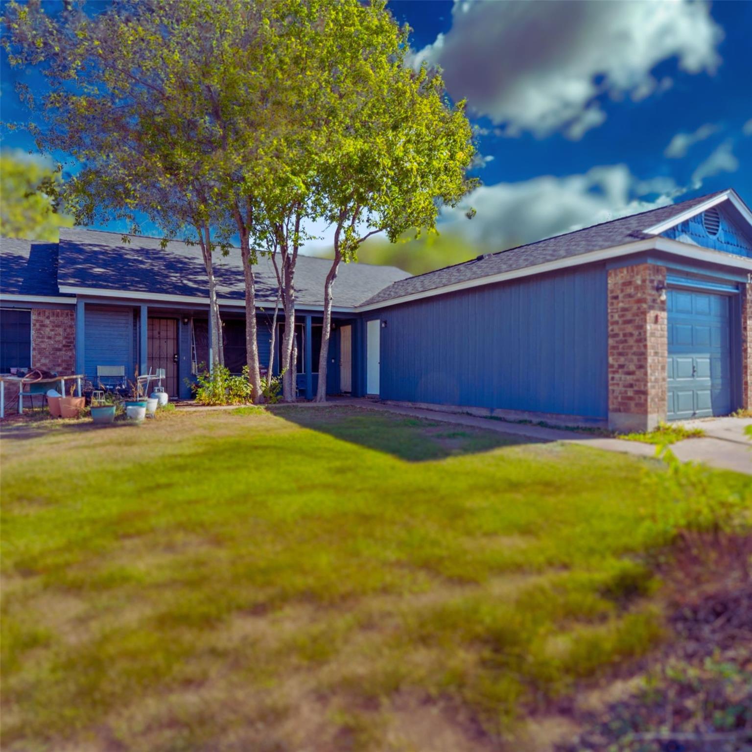 View of front of home featuring brick siding, a g