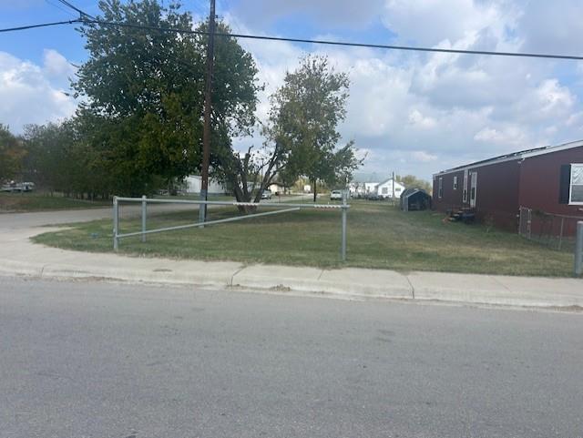View of asphalt street with sidewalks and curbs