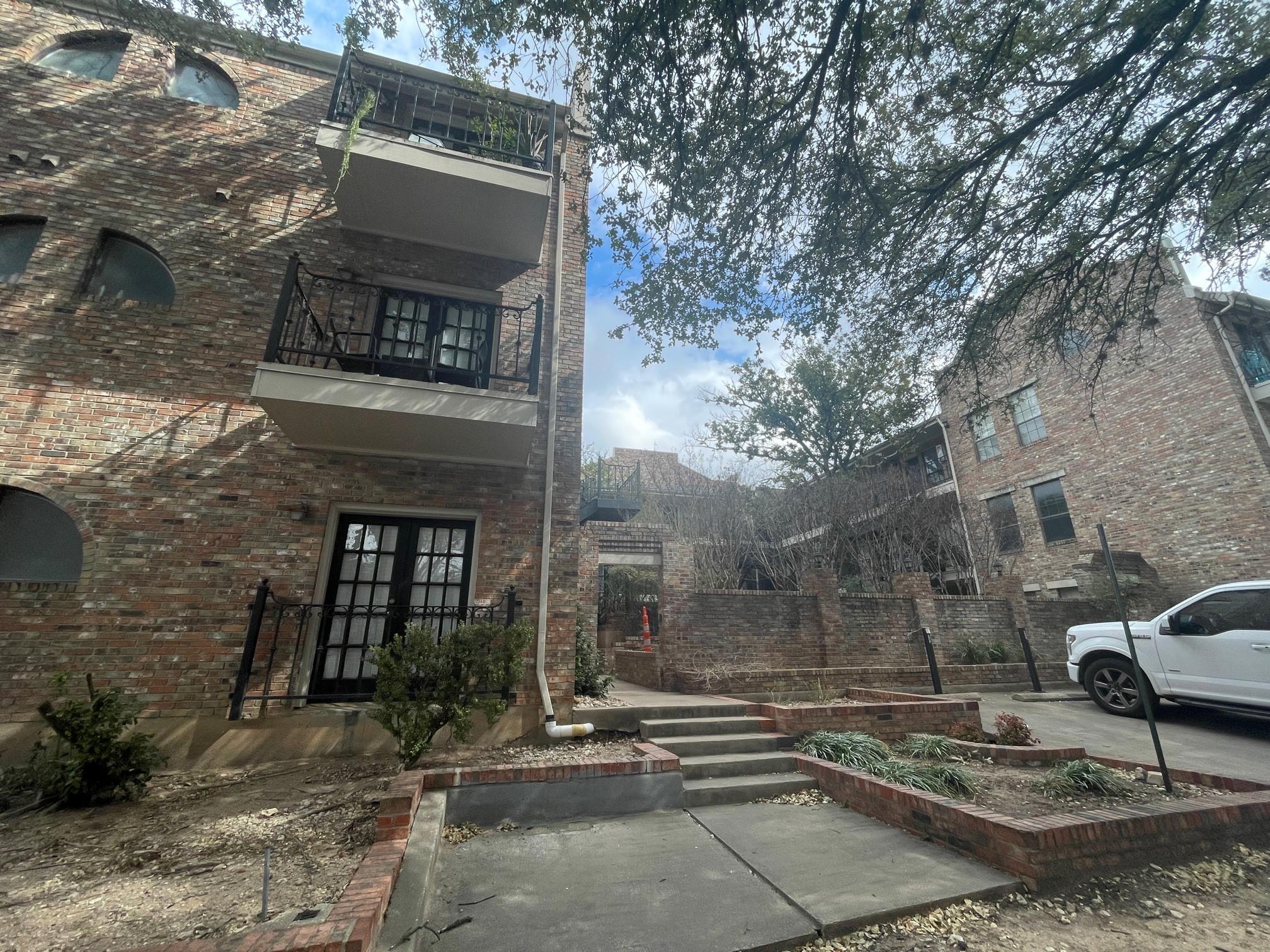 View of side of property featuring a balcony, bri