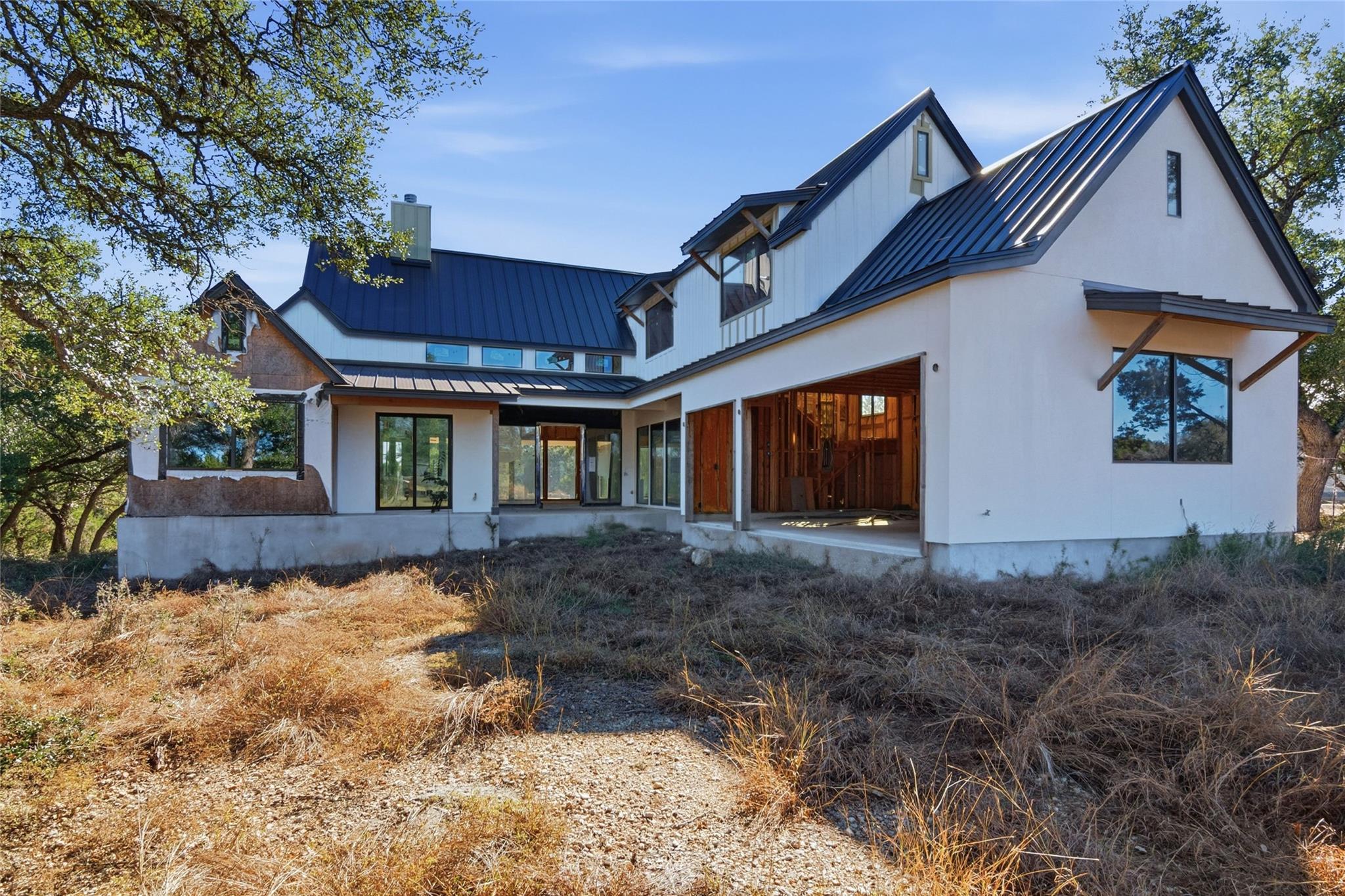 Back of property featuring a standing seam roof, 
