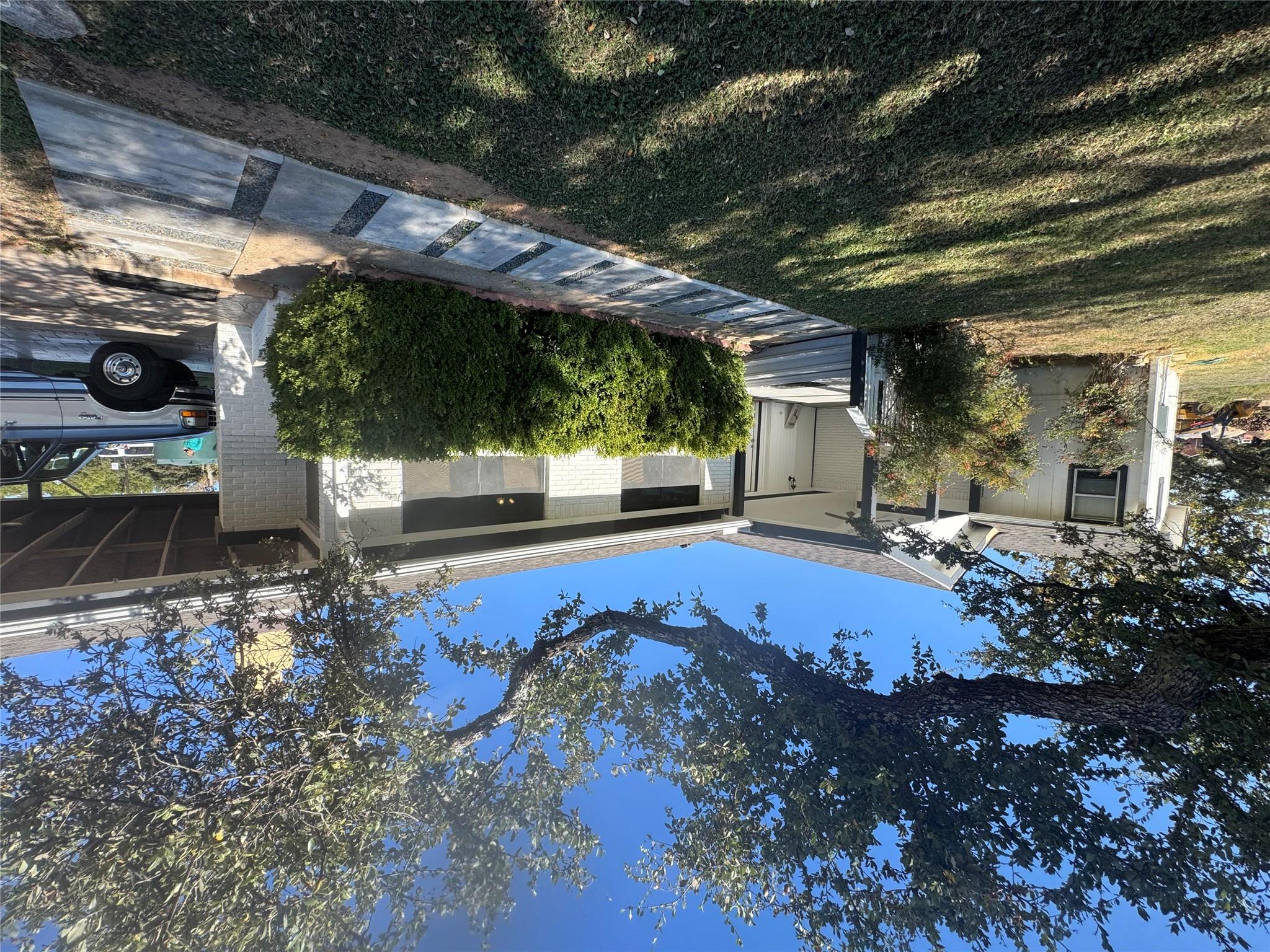 Ranch-style home with a front yard, a carport, an